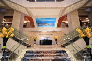 a spiral staircase in a building with a television at Ritz Carlton Residences DIFC Downtown Dubai in Dubai