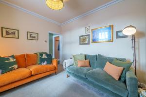 a living room with two couches and a lamp at 40 The Gill - Ulverston Town Centre in Ulverston