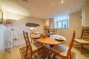 a kitchen and dining room with a wooden table and chairs at 40 The Gill - Ulverston Town Centre in Ulverston