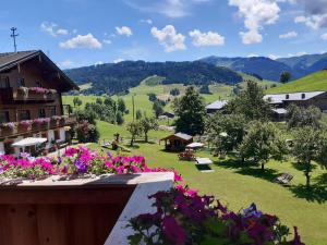 a view from the balcony of a house with flowers at Schranbachhof in Maria Alm am Steinernen Meer