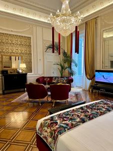 a living room with a couch and a tv at Palazzo Monga Boutique Guesthouse in Verona