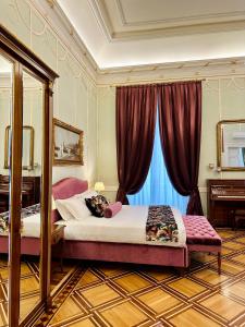 a bedroom with a bed with a mirror and a window at Palazzo Monga Boutique Guesthouse in Verona