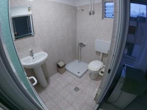 a bathroom with a sink and a toilet at Hostel Casa Mia SR in Sarandë