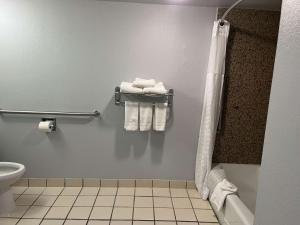 a bathroom with a toilet and towels on a rack at Studio 6 Suites Amarillo, TX West Medical Center in Amarillo
