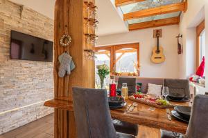 a dining room with a wooden table and chairs at Luxury Vineyard Retreat Matej - Happy Rentals in Trebnje