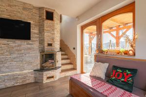 a living room with a fireplace and a tv at Luxury Vineyard Retreat Matej - Happy Rentals in Trebnje