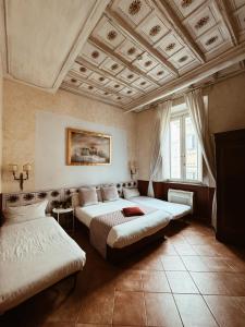 a bedroom with two beds and a coffered ceiling at Residenza Sciarra B&B in Rome