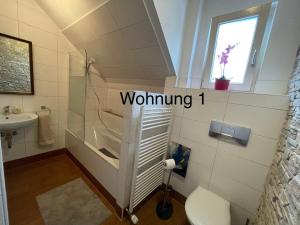 a bathroom with a toilet and a sink at Ferienwohung Weinheim in Weinheim