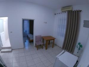 a small room with a table and a chair at Hostel Casa Mia SR in Sarandë