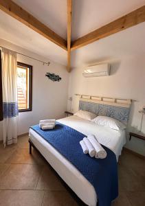 a bedroom with a bed with two towels on it at Villa Iole in Casale Azara
