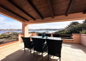 a table and chairs on a patio with a view of the ocean at Villa Iole in Casale Azara