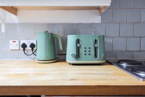 two green toasters sitting on top of a kitchen counter at Stylish Apartment in Putney in London