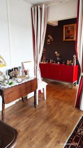 a living room with a table with figurines on it at Chambre Rafaël chez particulier in Cherbourg en Cotentin
