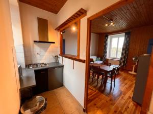 a kitchen and dining room with a table and a kitchen and a room at Le gite des mariniers in Saint-Pierre-de-Boeuf