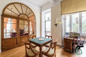 a dining room with a table and a desk at Hotiday Room Collection - Rapallo in Rapallo