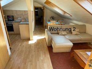 a living room with a couch and a kitchen at Ferienwohung Weinheim in Weinheim