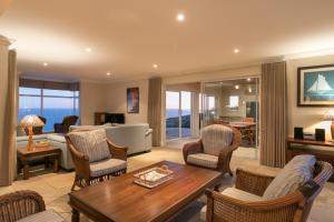 a living room with a table and chairs at Ocean House in Knysna