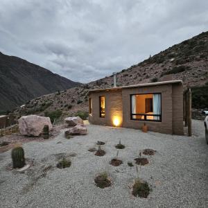 a small house in the middle of a mountain at Cabañas Bodega Kindgard in Purmamarca
