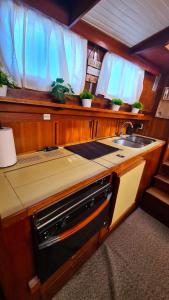 a kitchen with a sink and a stove at PIAM - Boat House in Faro