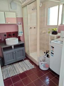 a bathroom with a shower and a sink and a toilet at Koloona in Wollongong