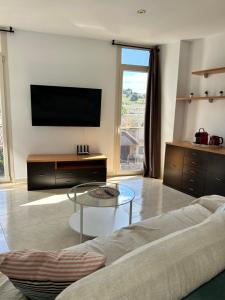 a living room with a flat screen tv on a wall at Apartaments Superiors MTB Only Couples in Lloret de Mar