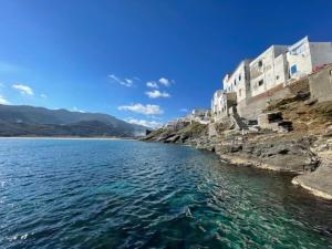 a view of a body of water next to buildings at The house of Nikos and Katerina 2 in Andros