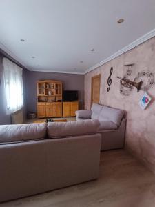 - un salon avec un canapé et un mur orné de dessins dans l'établissement Casa Alda, à Cabezuela