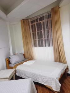 Postel nebo postele na pokoji v ubytování Pas-it Hostel Sagada