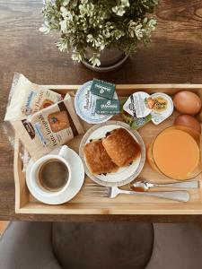 a tray with breakfast foods and a cup of coffee at Residenza Sciarra B&B in Rome
