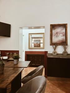 a living room with a table and chairs and a television at Residenza Sciarra B&B in Rome