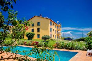 a villa with a swimming pool in front of a building at Kigali Village Suites in Kigali
