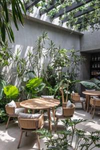 a patio with tables and chairs and plants at milenyum travel in Şile
