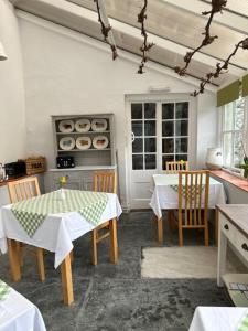 a kitchen with a table and chairs in a room at The Spinney in Barnstaple
