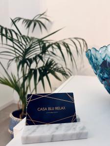 a blue box sitting on a table with a plant at Casa blu relax in Garda