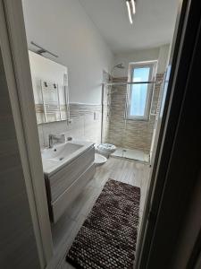 a bathroom with a tub and a sink and a toilet at Bella Puglia Bed and Breakfast in Ruvo di Puglia