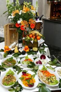a table with plates of food and a bottle of wine at Hotel Due Mondi in Turin