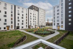 a courtyard with two white buildings and a playground at Walerego Sławka Cosy Studio in Krakow