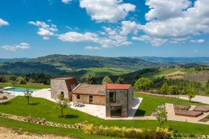 an aerial view of a house on a hill at Villa Velari In Volterra With Private Pool, AC in Volterra