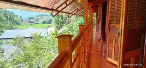 a balcony of a wooden house with a view at Higland Homestay Bac Ha in Bắc Hà +66 photos