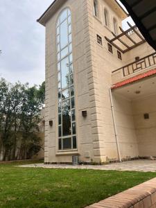 a building with a large window on the side of it at El dakroury king mariout villa in Naj‘ al Aḩwāl