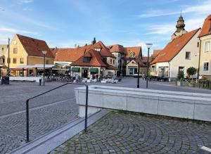 a street in a town with houses and buildings at Genuine Gotland house with large garden in Roma in Romakloster