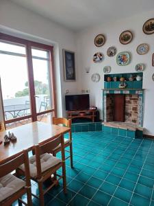a living room with a table and a fireplace at In Vacanza a Gaeta - Villa Nelda in Gaeta
