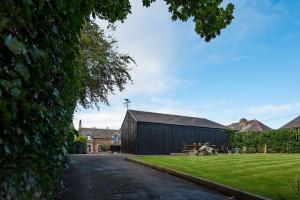 a barn with a picnic table in front of it at Coledale Stables in Kelso