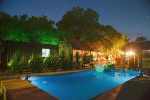 een zwembad voor een huis 's nachts bij Alme cabañas Olmué in Granizo