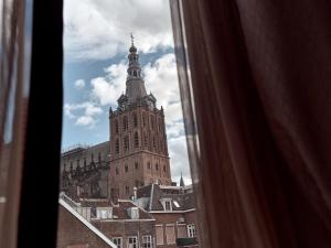 a view of a large building with a clock tower at Good Seasons Hotel Den Bosch in Den Bosch