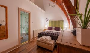 a hotel room with a bed and a bathroom at The Caledonian 3 Bedroom Self Catering Apartment in historic Abbey in Fort Augustus +18 photos