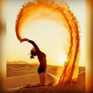 a woman is standing on a surfboard with a fire frame at hotel paru palace jaisalmer in Jaisalmer