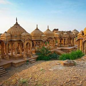 a large building with domes on top of a field at hotel paru palace jaisalmer in Jaisalmer