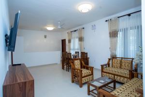 a room with a bunch of chairs and a table at The Islands Breeze Villa in Dehiwala