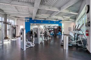 a gym with treadmills and elliptical machines at Blueground DTLA pool courtyard near dining LAX-1202 in Los Angeles